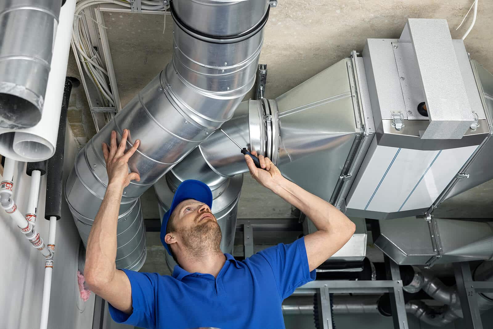 HVAC technician inspecting and repairing air ducts in Duarte