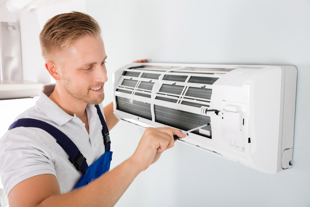 HVAC technician maintaining a ductless air conditioner in Duarte