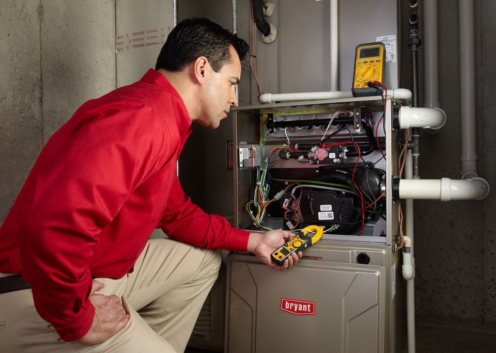 Heating technician diagnosing a furnace repair in Duarte
