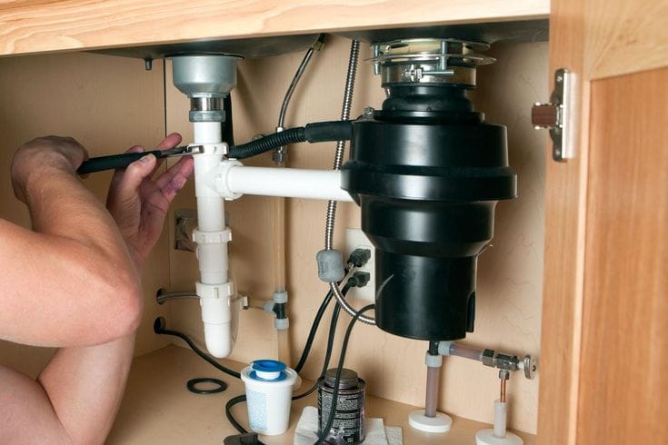 Plumber repairing a garbage disposal in Duarte