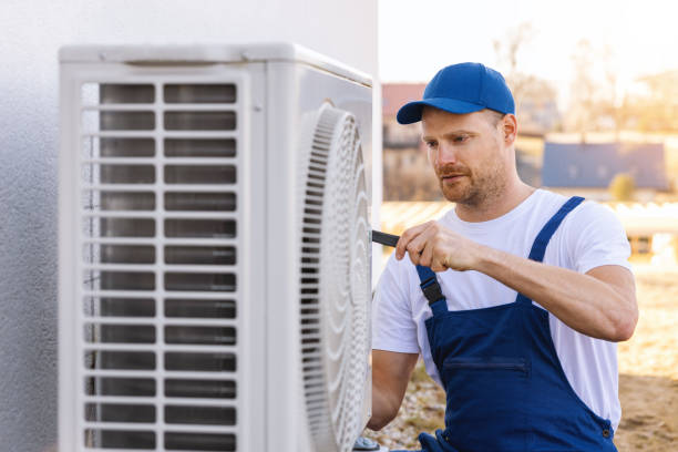 HVAC technician servicing an outdoor air conditioner in Duarte