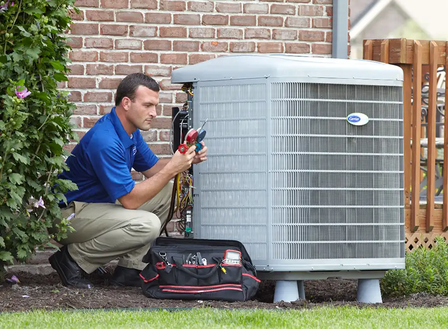 HVAC technician inspecting an outdoor AC unit in Duarte